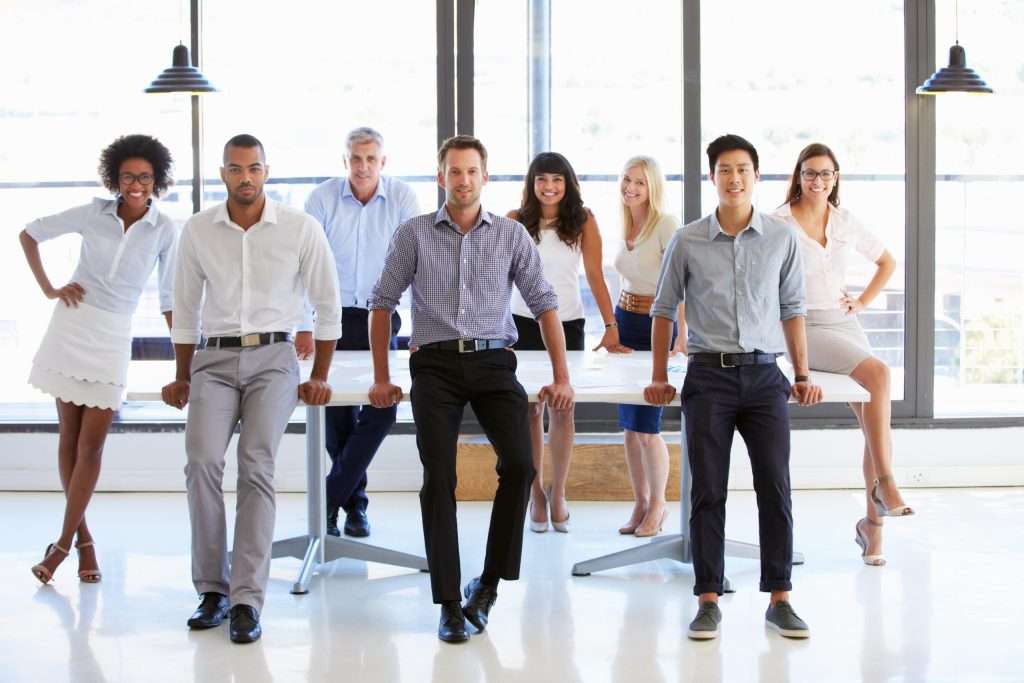 Confident and diverse team posing in a modern office with natural light