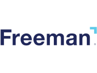 The image shows the word Freeman in dark blue bold text on a light background, with a small light blue right-angle accent mark above the last letter n.